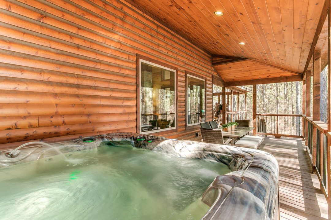 A hot tub nestled in the center of a cozy log cabin in Broken Bow, Oklahoma, perfect for relaxation and comfort.