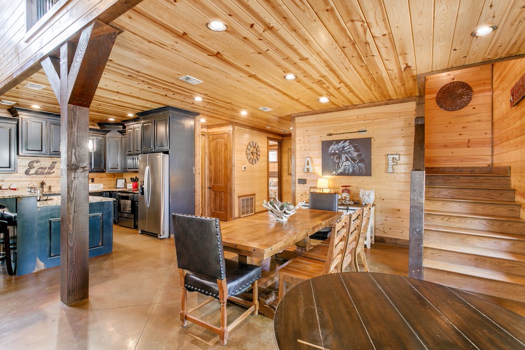 A cozy kitchen and dining area in a log home, showcasing rustic charm, perfect for Broken Bow, Oklahoma cabin lodging.